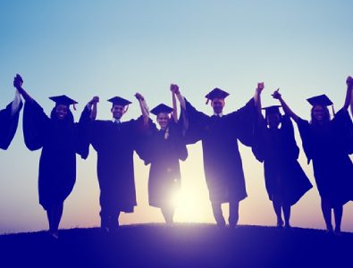 A Group Of Graduates Raising Hands In The Resemblence Of Their Graduation Success.