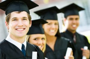 Group Of Graduate Students Smiling And Holding Their Degree.