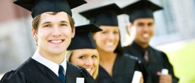 Group Of Graduate Students Smiling And Holding Their Degree.