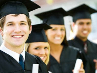 Group Of Graduate Students Smiling And Holding Their Degree.