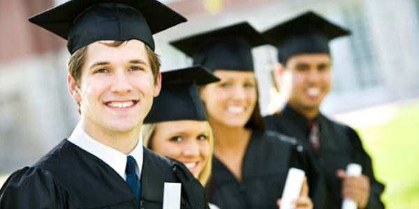 Group Of Graduate Students Smiling And Holding Their Degree.