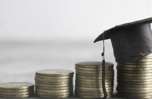 A Graduation Hat Placed Over The Coins.