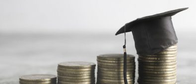 A Graduation Hat Placed Over The Coins.