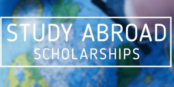 Study Abroad Scholarships Concept In Blue Background.