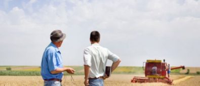 Two Persons Standing On The Ground & Discussing About Farming.