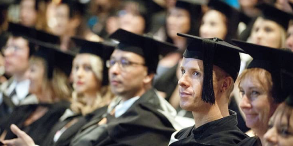 Group Of Abroad Students In Their Graduation Ceremony.