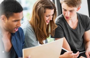 A Group of Three Collge Students Studying.