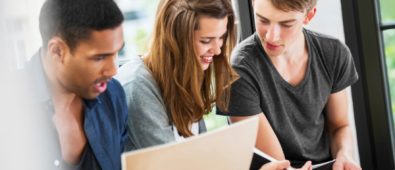 A Group of Three Collge Students Studying.