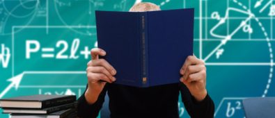 A Person Studying With A Book Hiding His Face.