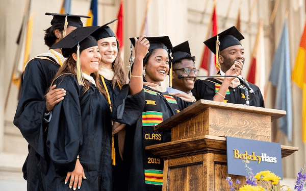 Group of Graduates Standing Over The Podium - Graduation Speech.