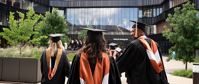 Canadian Students Dressed In Academic Dress With Graduate Cap Over Their Head.