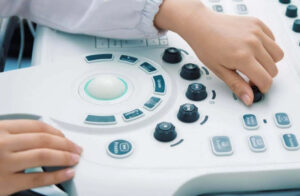 An individual operating the ultrasound machine