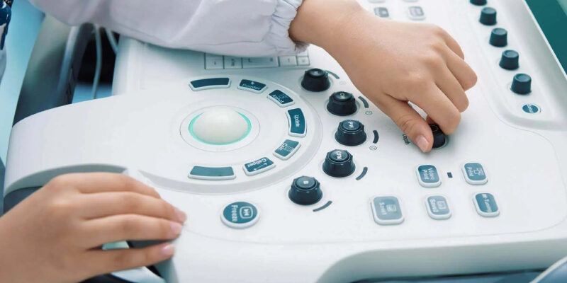 An individual operating the ultrasound machine