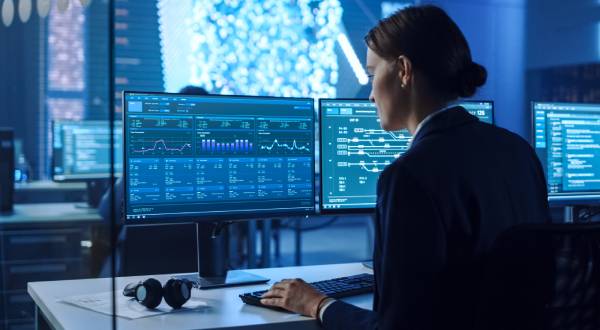 Rear view of a Female Data Scientist Working on a Computer.