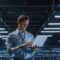 Portrait of a young male IT Specialist using Laptop in a Data Center.